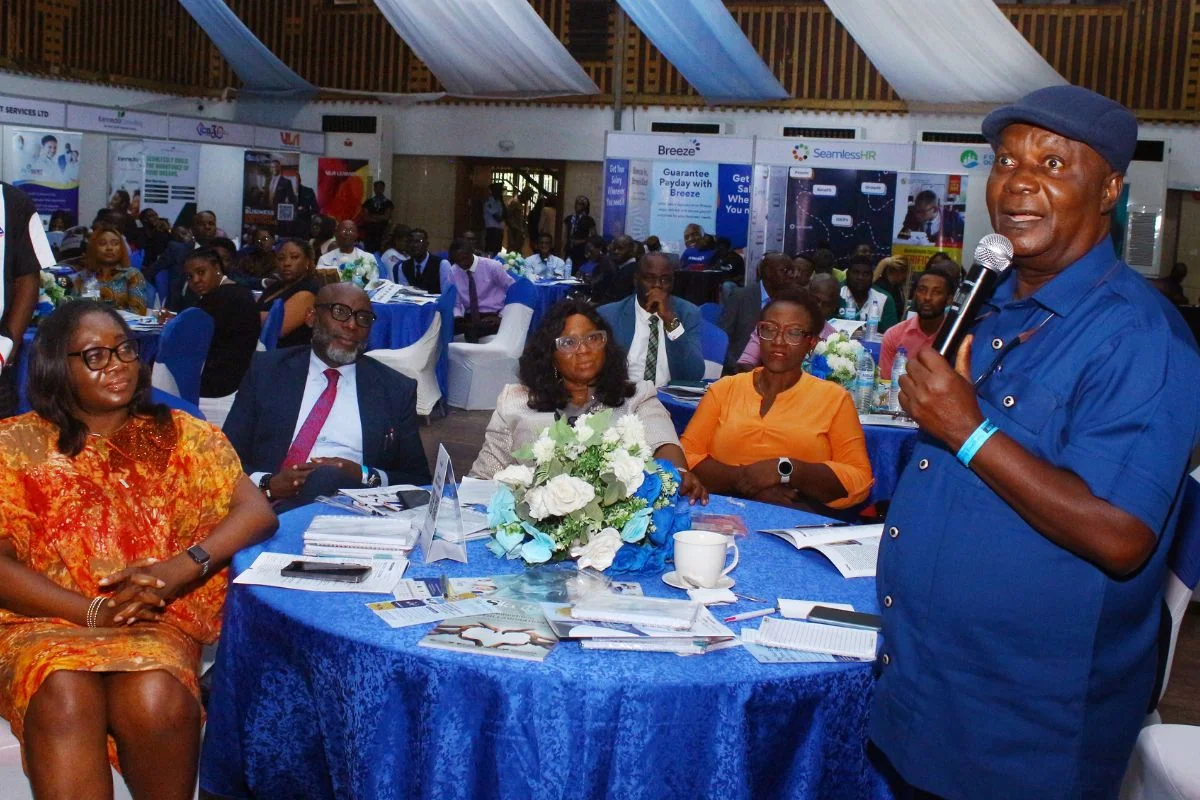 Speaker engaging attendees at their tables during Outsourcing Expo 2024